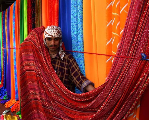 A man selling finished textiles.